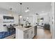 Open concept kitchen featuring a breakfast bar, stainless steel appliances, and ample natural light at 1620 Haddock St, St Cloud, FL 34771
