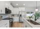 Modern kitchen with stainless steel appliances, white cabinets, and stylish backsplash at 1620 Haddock St, St Cloud, FL 34771