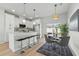 Open kitchen and dining area with stainless steel appliances and modern pendant lighting at 1620 Haddock St, St Cloud, FL 34771