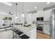 Open kitchen concept with stainless appliances, modern backsplash, breakfast bar and bright, airy feel at 1620 Haddock St, St Cloud, FL 34771