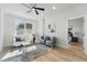 Bright living room featuring a ceiling fan, large window, and stylish decor at 1620 Haddock St, St Cloud, FL 34771