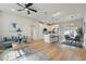 Open-concept living space with modern furnishings, a kitchen island, and a dining area at 1620 Haddock St, St Cloud, FL 34771