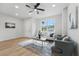 Inviting living room featuring a cozy seating arrangement, accent rug, and contemporary ceiling fan at 1620 Haddock St, St Cloud, FL 34771