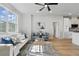 Bright, open living space with stylish furniture, hardwood floors, and a view into the kitchen at 1620 Haddock St, St Cloud, FL 34771