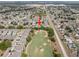 Aerial view of the house backing onto the golf course and neighborhood at 1631 Oak Hill Trl, Kissimmee, FL 34747
