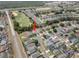 Aerial view of the property in a suburban neighborhood, with proximity to a golf course at 1631 Oak Hill Trl, Kissimmee, FL 34747