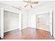 Bright bedroom with wood floors, ceiling fan, walk-in closet, and French doors leading to another room at 1631 Oak Hill Trl, Kissimmee, FL 34747