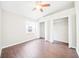 Bright bedroom features wood-look floors, ceiling fan, and closet storage at 1631 Oak Hill Trl, Kissimmee, FL 34747