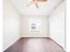 Well-lit bedroom featuring hardwood floors, a ceiling fan, and a closet with modern doors at 1631 Oak Hill Trl, Kissimmee, FL 34747