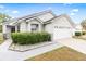Charming single-story home featuring a well-maintained front yard, attached garage, and neutral exterior paint at 1631 Oak Hill Trl, Kissimmee, FL 34747