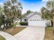 Charming single-Gathering home with a two-car garage and well-manicured front yard at 1631 Oak Hill Trl, Kissimmee, FL 34747