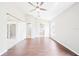 Spacious main bedroom boasts wood-look floors, ceiling fan, and en-suite bathroom at 1631 Oak Hill Trl, Kissimmee, FL 34747