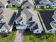 An elevated view of a well maintained white two-story home with a brick driveway and neat landscaping at 19065 Blueleaf St, Orlando, FL 32827