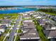 An aerial view of a new construction community near a large blue lake at 19065 Blueleaf St, Orlando, FL 32827
