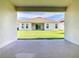 View of backyard from covered porch, featuring a well-maintained lawn and a new house exterior at 19065 Blueleaf St, Orlando, FL 32827