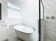 Relax in this bathroom featuring a soaking tub and a separate glass enclosed shower at 19065 Blueleaf St, Orlando, FL 32827