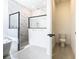 Bright bathroom showcasing a soaking tub, glass-enclosed shower, and modern fixtures at 19065 Blueleaf St, Orlando, FL 32827