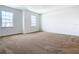 Neutral bedroom with light carpeting, white walls, and two windows at 19065 Blueleaf St, Orlando, FL 32827