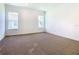 Bright bedroom featuring neutral carpet, white walls, and two windows allowing for ample natural light at 19065 Blueleaf St, Orlando, FL 32827