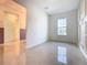 Bright, versatile room with tile flooring, a window view, and classic wall detailing at 19065 Blueleaf St, Orlando, FL 32827