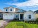Charming two-story home featuring a three-car garage, beautiful stone accents, and a well-manicured lawn at 19065 Blueleaf St, Orlando, FL 32827