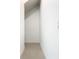 Narrow hallway with neutral tile flooring and clean white walls at 19065 Blueleaf St, Orlando, FL 32827