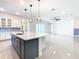 Open-concept kitchen boasts a large island, white cabinets, and ample natural light at 19065 Blueleaf St, Orlando, FL 32827