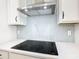 Modern kitchen featuring a sleek cooktop, stylish backsplash, and high-end fixtures for culinary enthusiasts at 19065 Blueleaf St, Orlando, FL 32827
