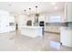 Bright, modern kitchen with white cabinets, stainless steel appliances, and a large central island at 19065 Blueleaf St, Orlando, FL 32827
