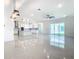 Open-concept living room and kitchen featuring sleek appliances, and glossy tile flooring at 19065 Blueleaf St, Orlando, FL 32827