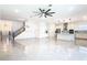 Open-concept living room and kitchen featuring sleek appliances, and glossy tile flooring at 19065 Blueleaf St, Orlando, FL 32827