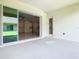 Covered patio with sliding glass doors leading to the home's interior at 19065 Blueleaf St, Orlando, FL 32827
