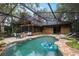 Aerial view of the backyard featuring a pool, firepit, patio, house, and screen enclosure at 2114 Bluff Oak St, Apopka, FL 32712