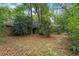 Landscaped backyard with trees and a stone path leading to the house at 2114 Bluff Oak St, Apopka, FL 32712