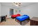 Bedroom with wood-look flooring, ceiling fan, natural light, desk, and two twin beds at 2114 Bluff Oak St, Apopka, FL 32712