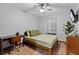 Cozy bedroom features wood-look flooring, ceiling fan, lots of natural light, and a built-in desk at 2114 Bluff Oak St, Apopka, FL 32712