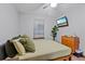 Cozy bedroom features wood-look flooring, ceiling fan, lots of natural light, and a built-in desk at 2114 Bluff Oak St, Apopka, FL 32712