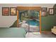 Bedroom view to a screened-in pool with a waterfall feature outside sliding glass doors at 2114 Bluff Oak St, Apopka, FL 32712