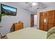 Bedroom with a view, hardwood floors, closet, ceiling fan and a mounted TV at 2114 Bluff Oak St, Apopka, FL 32712