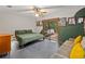 Bedroom features a view of the screened backyard pool and patio, and a comfortable sofa at 2114 Bluff Oak St, Apopka, FL 32712