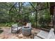 Relaxing outdoor space with a firepit, patio furniture, and enclosed in a screened patio at 2114 Bluff Oak St, Apopka, FL 32712
