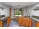 Kitchen featuring wood cabinets, stainless steel appliances, and granite countertops at 2114 Bluff Oak St, Apopka, FL 32712