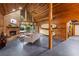 Spacious living room with a stone fireplace, wood paneling, and an attached sunroom at 2114 Bluff Oak St, Apopka, FL 32712