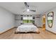 Bright main bedroom boasts hardwood floors, natural light, ceiling fan, and ensuite bath and walk-in closets at 2114 Bluff Oak St, Apopka, FL 32712