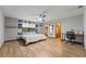 Bright main bedroom boasts hardwood floors, natural light, ceiling fan, and ensuite bath and walk-in closets at 2114 Bluff Oak St, Apopka, FL 32712
