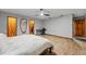 Bright main bedroom boasts hardwood floors, natural light, ceiling fan, and ensuite bath and walk-in closets at 2114 Bluff Oak St, Apopka, FL 32712