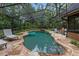 Backyard pool featuring an enclosed screen with view of the house and a cozy firepit at 2114 Bluff Oak St, Apopka, FL 32712