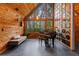 Sitting room featuring wood walls, a piano, and a large window with natural light at 2114 Bluff Oak St, Apopka, FL 32712