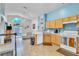 Open kitchen overlooking the living room area with bright white appliances and ample counter space at 2122 Korat Ln, Maitland, FL 32751