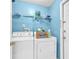 Practical laundry room with a washer, dryer, and shelving for supplies at 2122 Korat Ln, Maitland, FL 32751